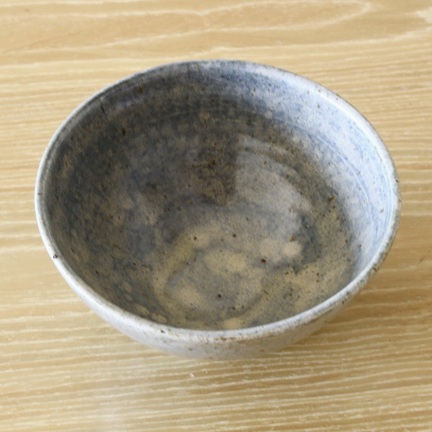 Pottery bowl in blue color and dappled glaze