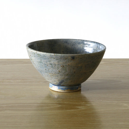 Pottery bowl in blue color and dappled glaze